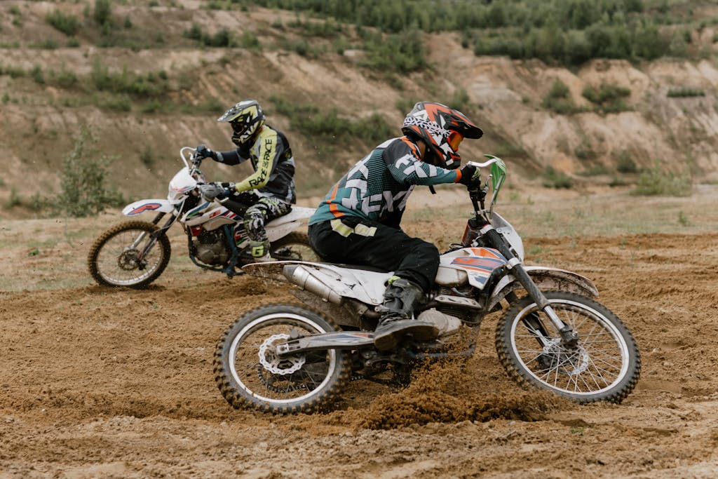 Exciting motocross action showcasing two riders tackling an off-road dirt track.